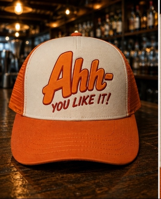 AHH! Trucker Hat in cream and burnt orange on a bar top